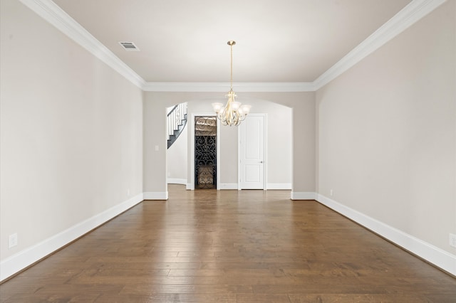 unfurnished dining area featuring crown molding, dark wood-type flooring, and an inviting chandelier