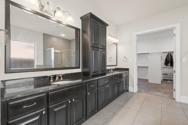 bathroom with vanity, tile patterned floors, and a shower with shower door