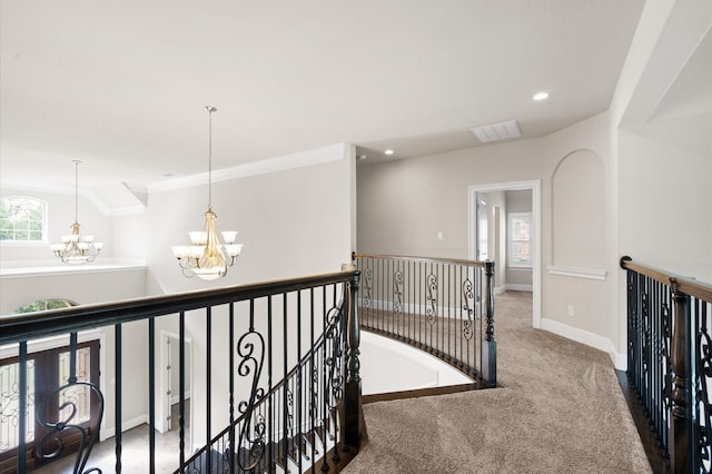 hall with carpet and a chandelier