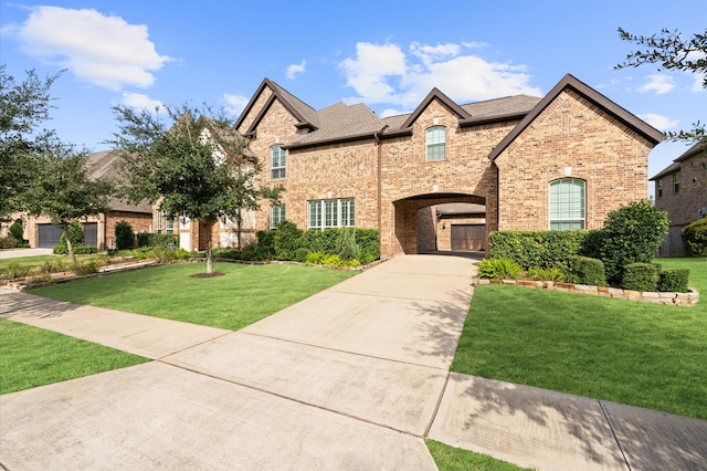 view of front of property with a garage and a front lawn