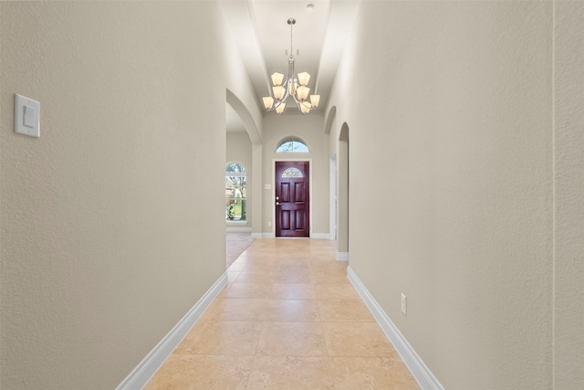 interior space featuring light tile patterned floors and a notable chandelier