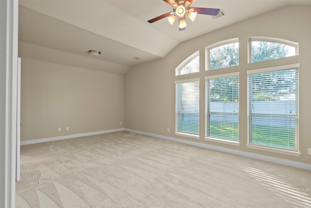 empty room with ceiling fan, light carpet, and vaulted ceiling