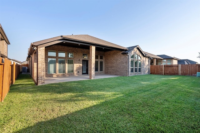 back of house with a lawn, a patio area, and cooling unit