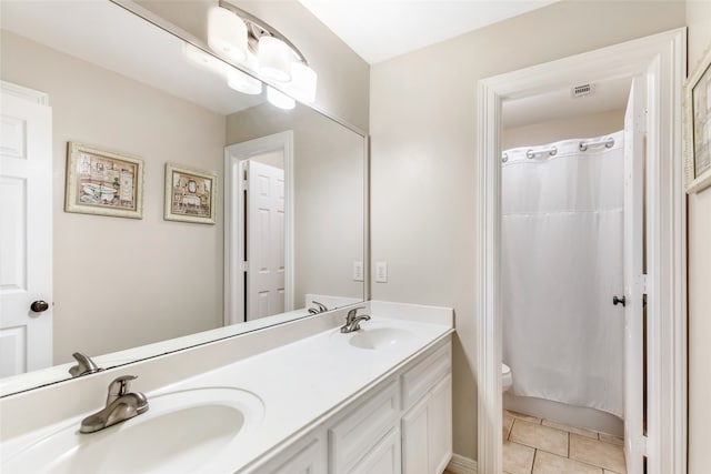 bathroom with tile patterned floors, a shower with curtain, vanity, and toilet