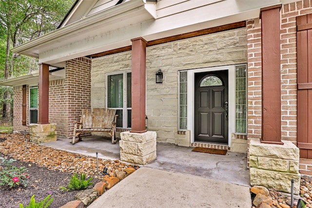 doorway to property featuring covered porch