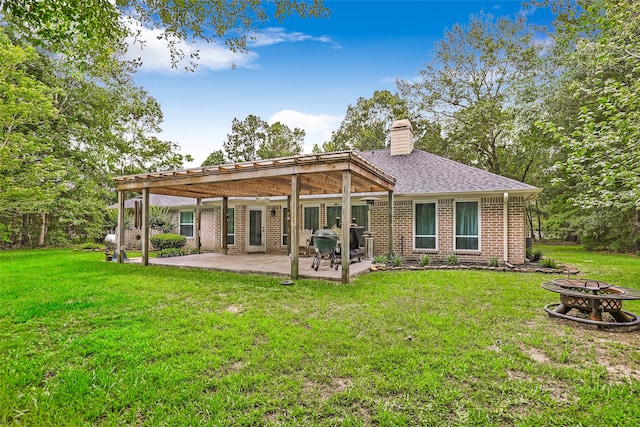 rear view of property with a yard and a patio