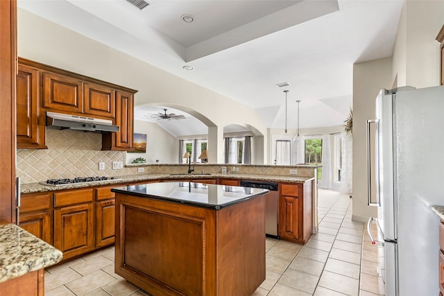 kitchen with appliances with stainless steel finishes, ceiling fan, sink, light tile patterned floors, and a center island