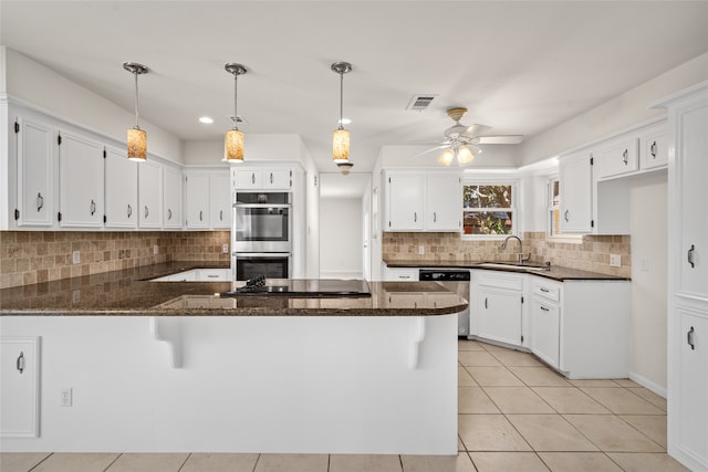 kitchen with ceiling fan, sink, kitchen peninsula, white cabinets, and appliances with stainless steel finishes