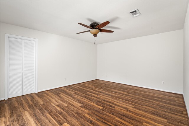 1133 Sally Anne Dr, Rosenberg, TX 77471 - unfurnished bedroom featuring dark wood-style flooring, baseboards, and a ceiling fan
