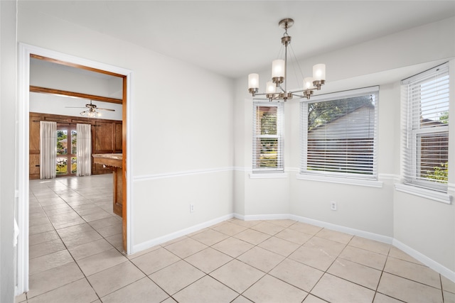 spare room with light tile patterned flooring and ceiling fan with notable chandelier