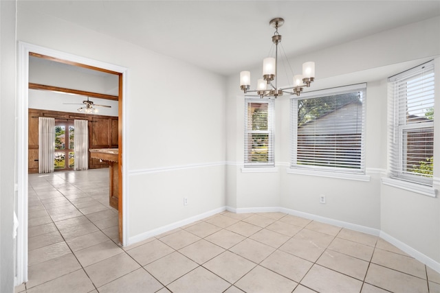 1133 Sally Anne Dr, Rosenberg, TX 77471 - unfurnished dining area featuring a chandelier, light tile patterned flooring, and baseboards