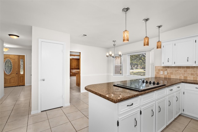 1133 Sally Anne Dr, Rosenberg, TX 77471 - kitchen featuring black electric cooktop, a peninsula, white cabinets, light tile patterned floors, and a chandelier