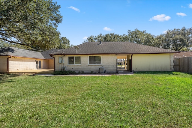 back of house featuring a yard and a patio area