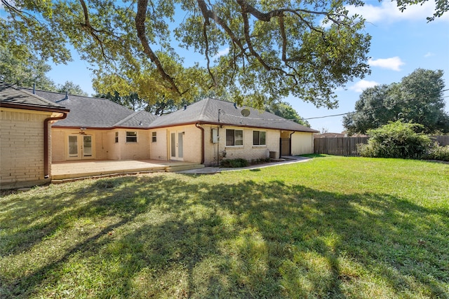 back of house with a yard and a patio area