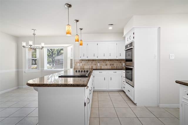 kitchen featuring pendant lighting, white cabinetry, double oven, black electric stovetop, and decorative backsplash