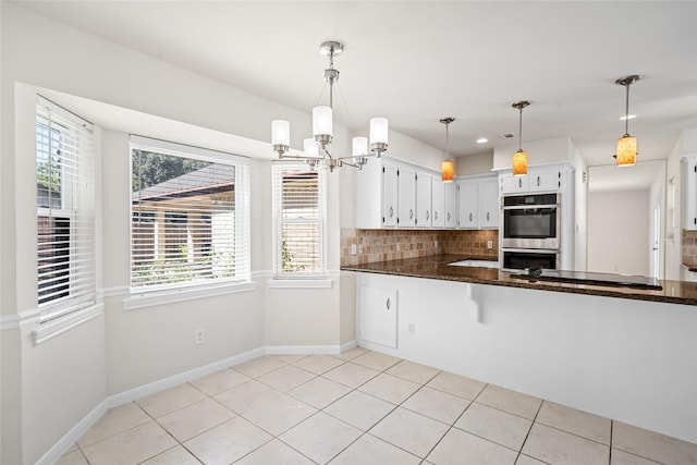 1133 Sally Anne Dr, Rosenberg, TX 77471 - kitchen with stainless steel double oven, plenty of natural light, decorative backsplash, a chandelier, and recessed lighting
