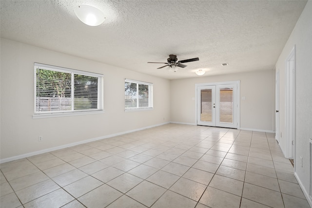 unfurnished room featuring ceiling fan, plenty of natural light, french doors, and light tile patterned floors