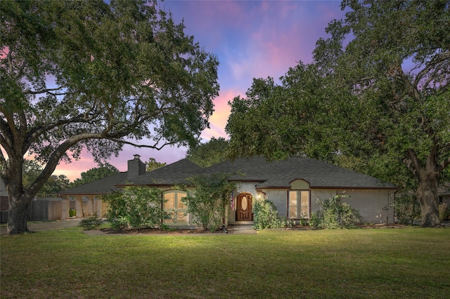 view of front of home with a lawn