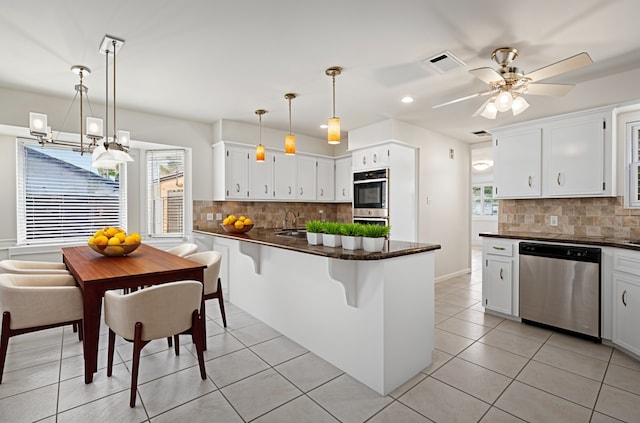 1133 Sally Anne Dr, Rosenberg, TX 77471 - kitchen with stainless steel appliances, decorative backsplash, recessed lighting, a peninsula, and light tile patterned floors