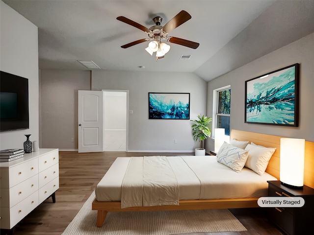 bedroom featuring ceiling fan, vaulted ceiling, and dark hardwood / wood-style flooring