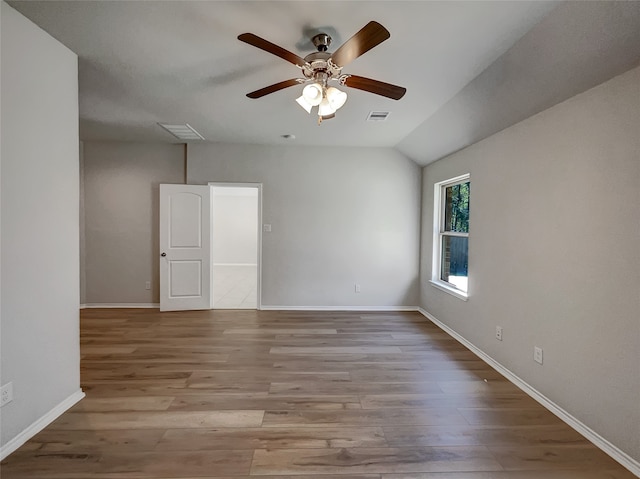 unfurnished room featuring ceiling fan, vaulted ceiling, and light hardwood / wood-style floors