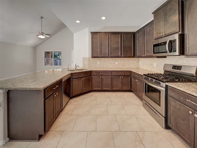 kitchen featuring dark brown cabinetry, stainless steel appliances, light tile patterned floors, and lofted ceiling