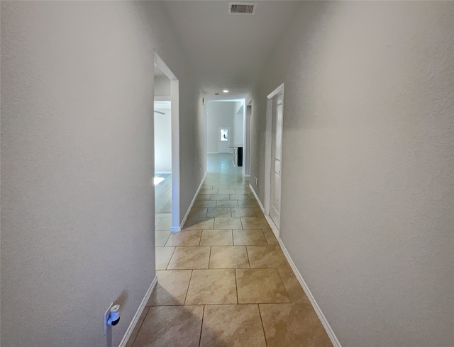 hall with light tile patterned floors