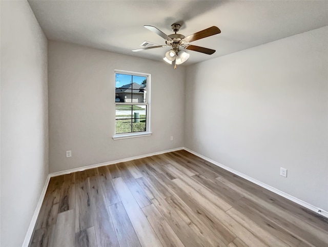 spare room with light hardwood / wood-style flooring and ceiling fan