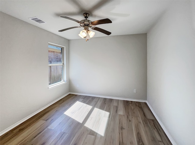 empty room featuring ceiling fan and light hardwood / wood-style flooring