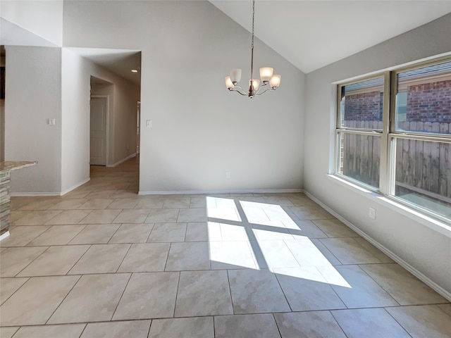 empty room with vaulted ceiling, an inviting chandelier, and light tile patterned floors