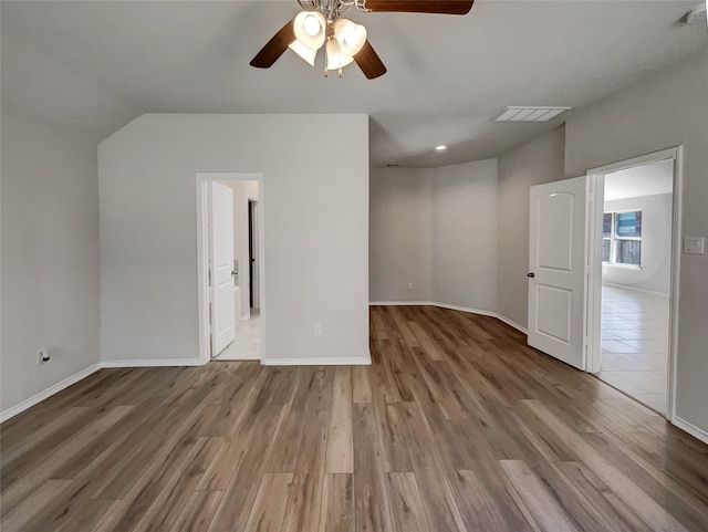 interior space featuring wood-type flooring, lofted ceiling, and ceiling fan