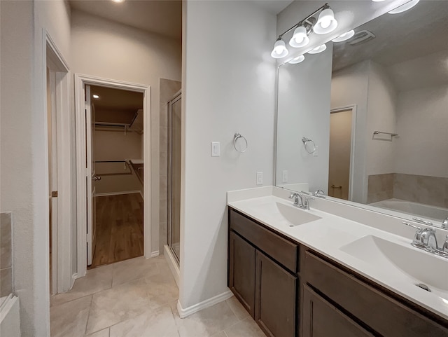 bathroom with tile patterned flooring, separate shower and tub, and vanity