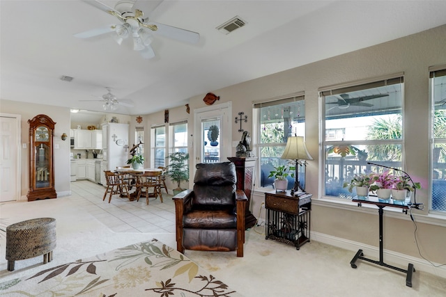 carpeted living room featuring ceiling fan