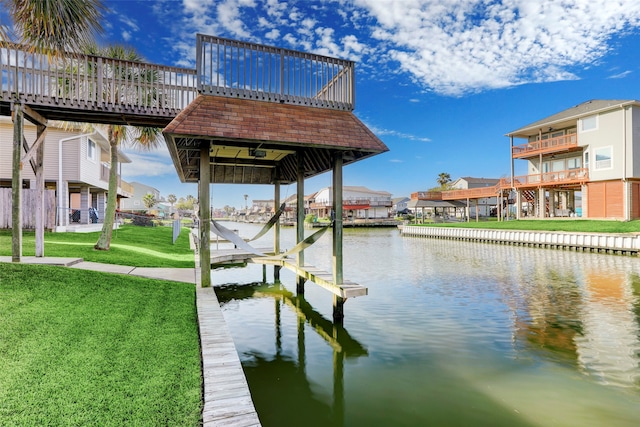 view of dock featuring a water view and a lawn