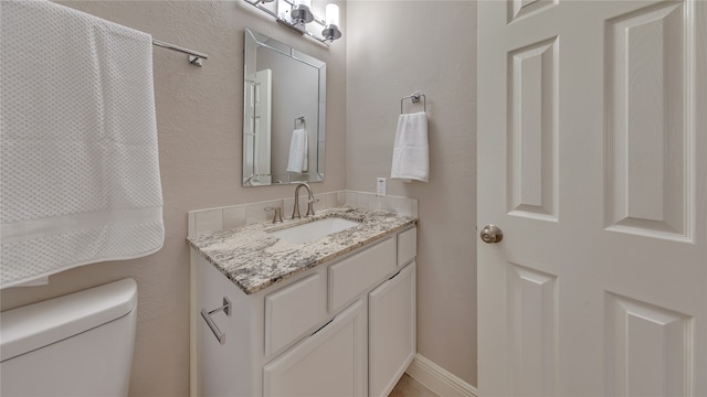 bathroom featuring toilet and vanity