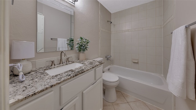 full bathroom featuring vanity, tiled shower / bath, tile patterned flooring, toilet, and a textured ceiling