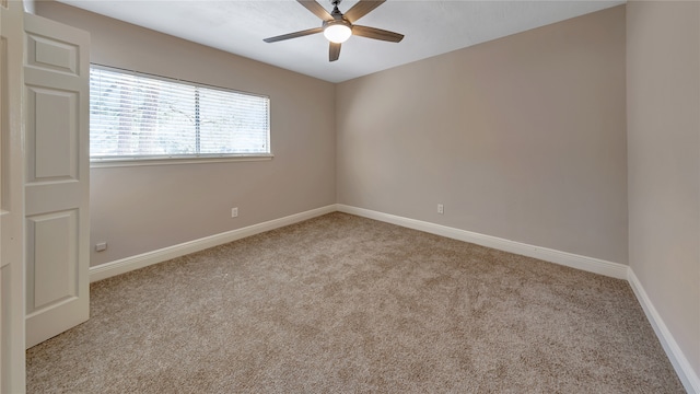 empty room featuring light colored carpet and ceiling fan