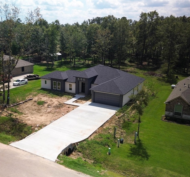 view of front of home featuring a garage and a front lawn