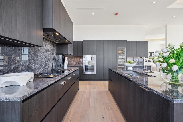 kitchen featuring cooktop, a sink, and modern cabinets