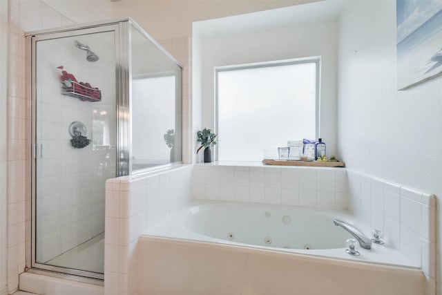 bathroom with shower with separate bathtub