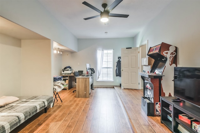 workout room with light hardwood / wood-style flooring and ceiling fan