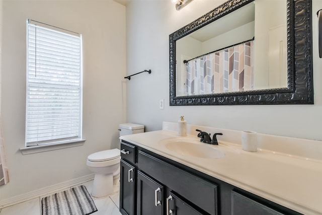 bathroom featuring tile patterned floors, vanity, and toilet