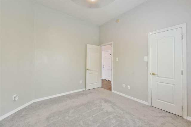 unfurnished room with light colored carpet