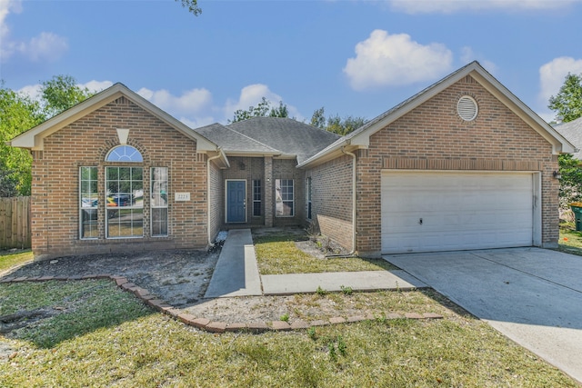 view of front of house featuring a garage and a front lawn