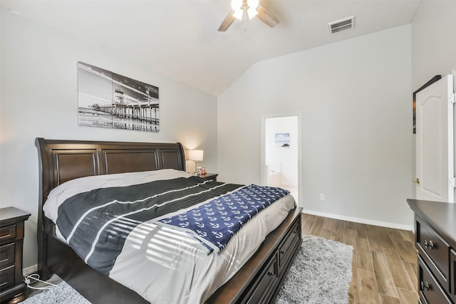 bedroom featuring lofted ceiling, connected bathroom, light hardwood / wood-style flooring, and ceiling fan