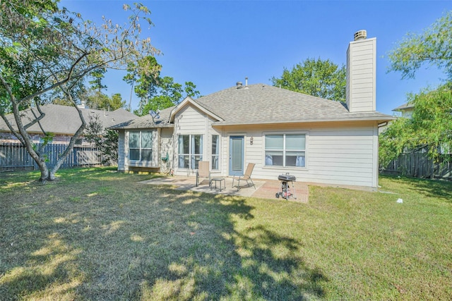 back of house featuring a yard and a patio area