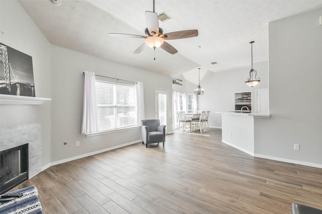 unfurnished room with sink, vaulted ceiling, light hardwood / wood-style floors, and ceiling fan