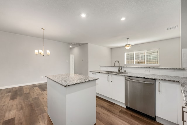 kitchen featuring white cabinets, pendant lighting, sink, dishwasher, and dark hardwood / wood-style floors