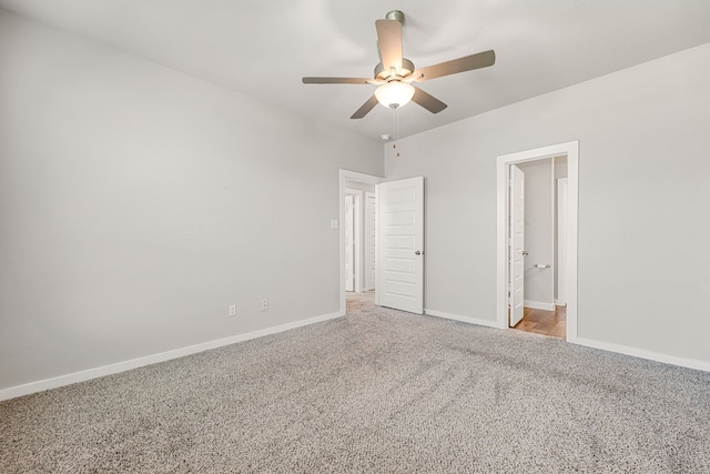 unfurnished bedroom with ceiling fan, ensuite bath, and carpet