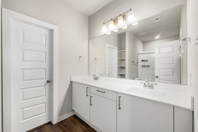 bathroom with walk in shower, hardwood / wood-style flooring, and vanity